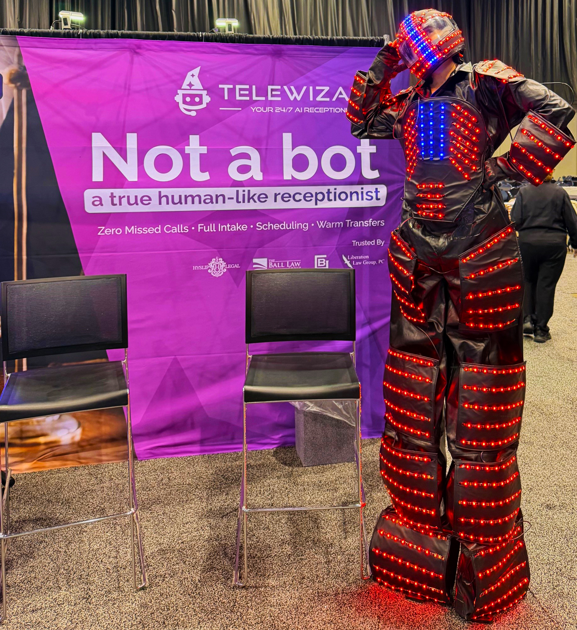 Performer in illuminated robot suit near TeleWizard booth at ABA TECHSHOW 2026